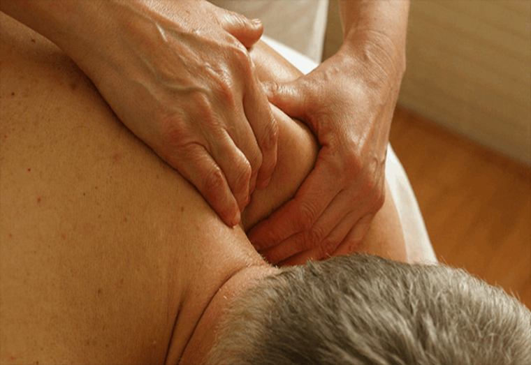 A man receiving a massage at a chiropractic clinic in Chatswood.